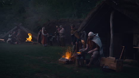 medieval village craftsman at work at night