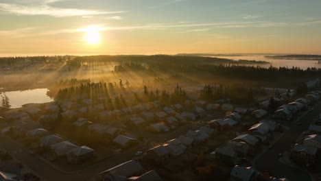 establishing aerial shot of washington neighborhood with the sunrise cutting through the morning fog
