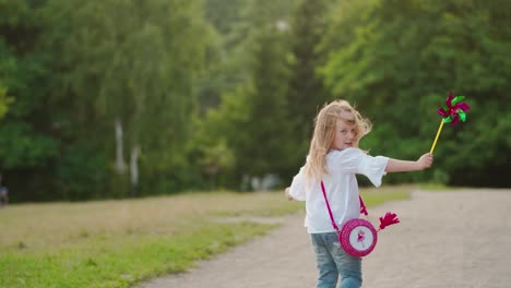 little girl with pinwheel. cute little child girl with pinwheel in the park