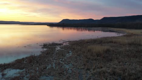 sunrise/sunset over a calm river with marsh and forest