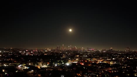 aerial hyperlapse of downtown los angeles under the full buck moon at night in southern california. 4k