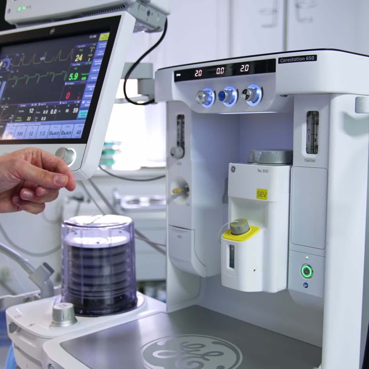 Male doctor's hand pointing at the anesthesia delivery system. Doctor explaining the work and demonstrating new equipment