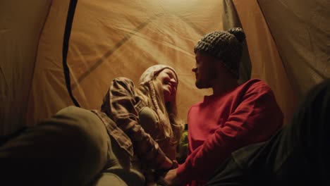 caucasian couple camping in nature by night