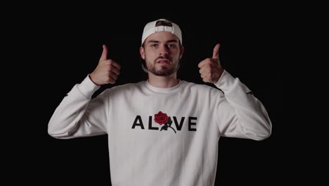 trendy 20s man giving both thumbs up, appreciative gesture, wide, black background