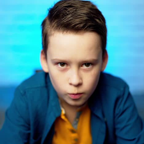 close up portrait of a sad boy looking at the camera