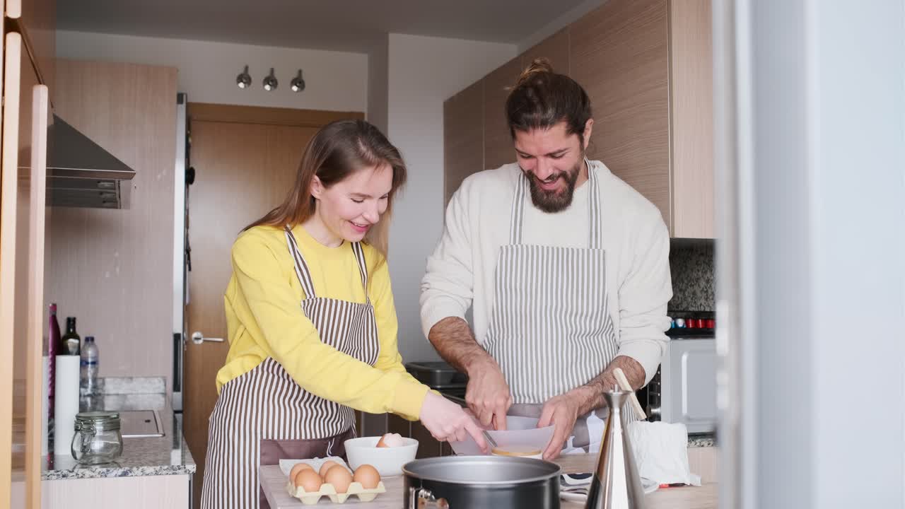 Couple baking together in the kitchen