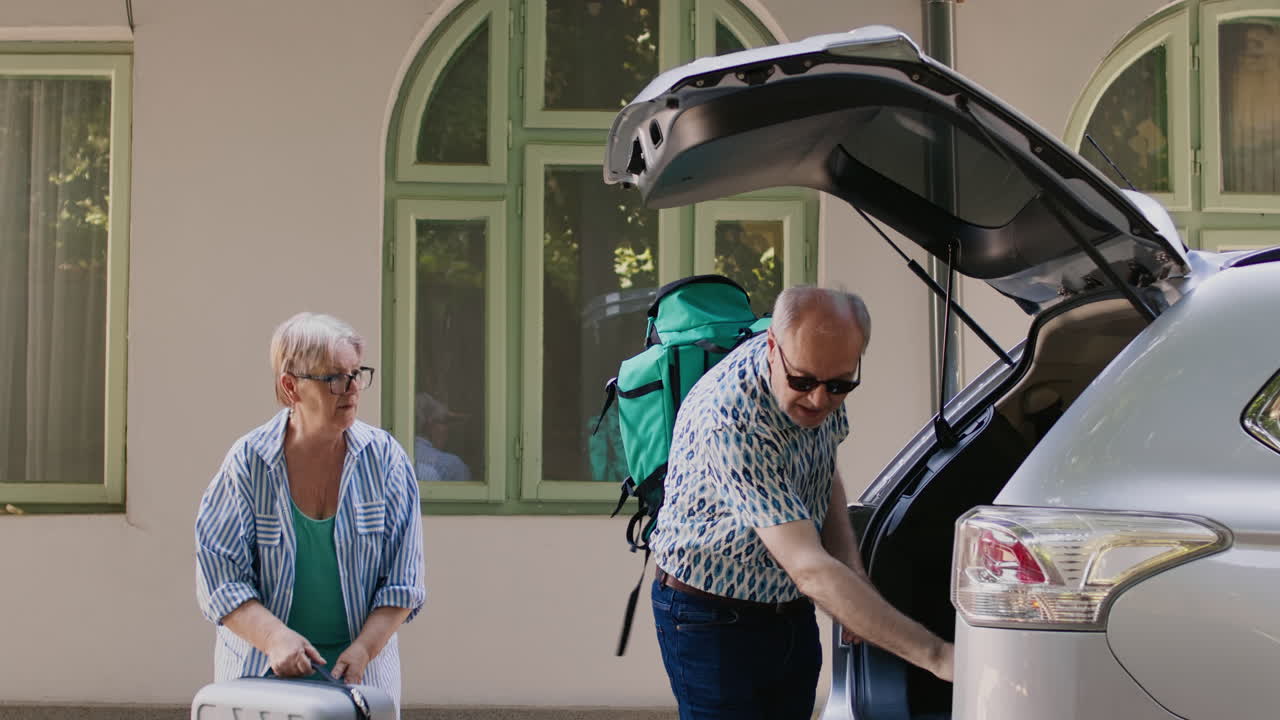 Senior Couple Packing Car for Road Trip