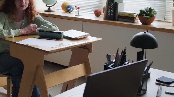 Teenage Girl Studying at Desk in Classroom