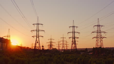 high voltage electric towers at sunset. transmission power line. parts of electrical equipment and high voltage power line insulators in the evening.
