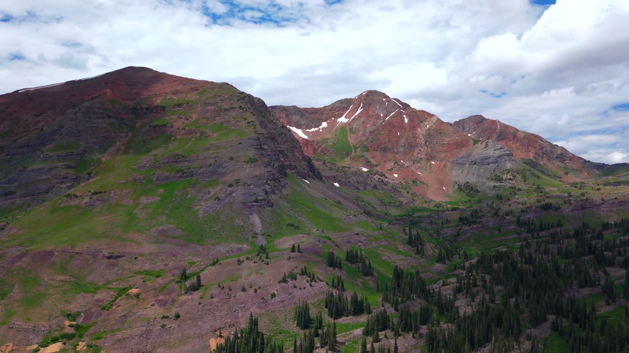 Ruby Peak Kebler Pass Lake Irwin Trailhead spring summer aerial drone Robinson Basin Crested Butte Colorado Gunnison National Forest morning daytime blue sky clouds snow fields forward motion