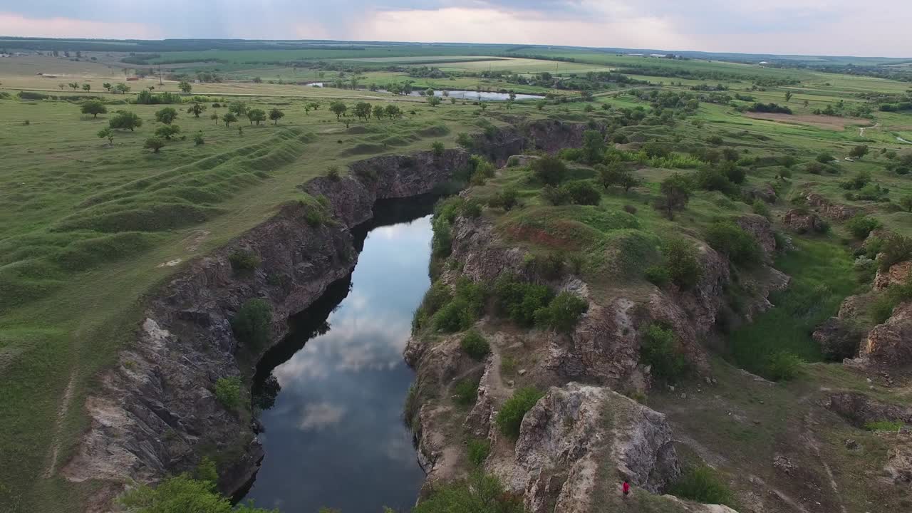 Sunset over the small canyon with rocky shores
