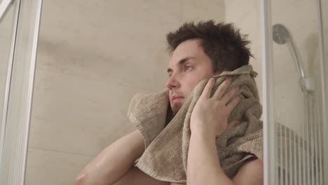 man washing his hair in a shower