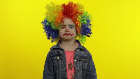 Little-child-girl-clown-in-colorful-wig-receives-money-income-in-banknotes-dollar-cash.-Smiling