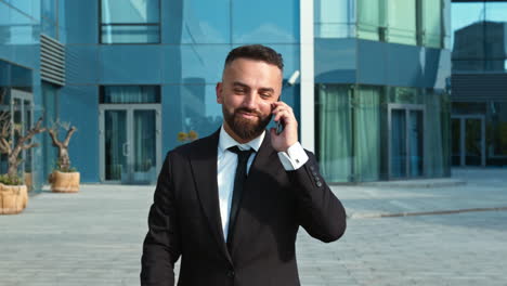 businessman on phone call outside modern office building