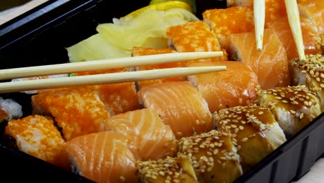 japanese sushi rolls with chopsticks rotates