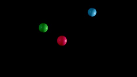 multicolored balls bouncing against a black background