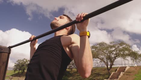 Young man training at an outdoor gym bootcamp