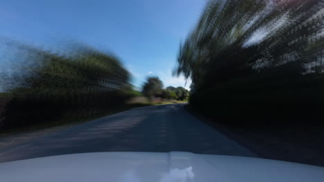 Coastal-sandy-dunes-and-asphalt-road-on-windy-day,-driving-POV-time-lapse