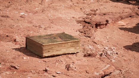 old book in red rock desert