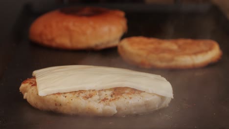 cooking american fat smash burger on grill close-up. chiken or fish cutlet smashing by burger press. the chef in kitchen of the restaurant making cutlets for burgers - smash burger beefsteak. fast and street food concept. high quality 4k footage