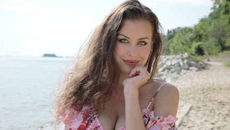 portrait of a beautiful brunette woman smiling on the beach