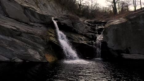 drone still flight over water in near of a waterfall at daytime