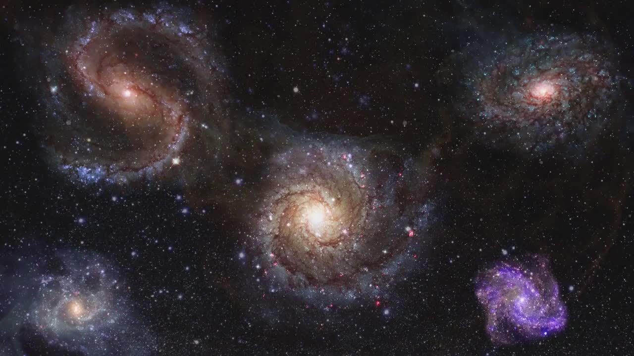 Galaxies against a backdrop of stars in deep space.