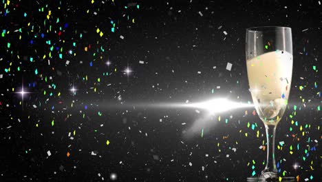 animation of stars and confetti over glass of champagne