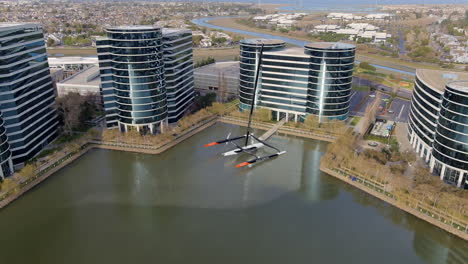 Aerial-View-Of-Oracle-Offices-And-Oracle-Team-USA-Trimaran-In-Lake-Larry,-Redwood-City,-California,-USA