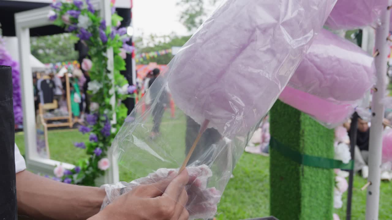 Concert vendor preparing wrapping tasty Sweet Candy Floss treats