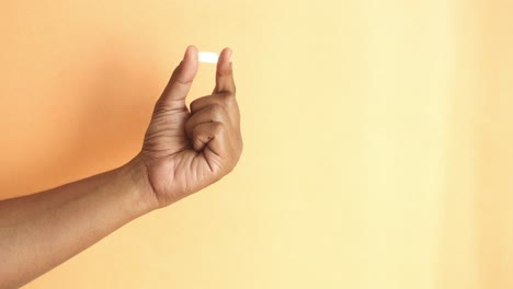 hand holding a pill