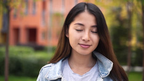 outdoor portrait of a beautiful japanese girl looking and smiling at camera 5