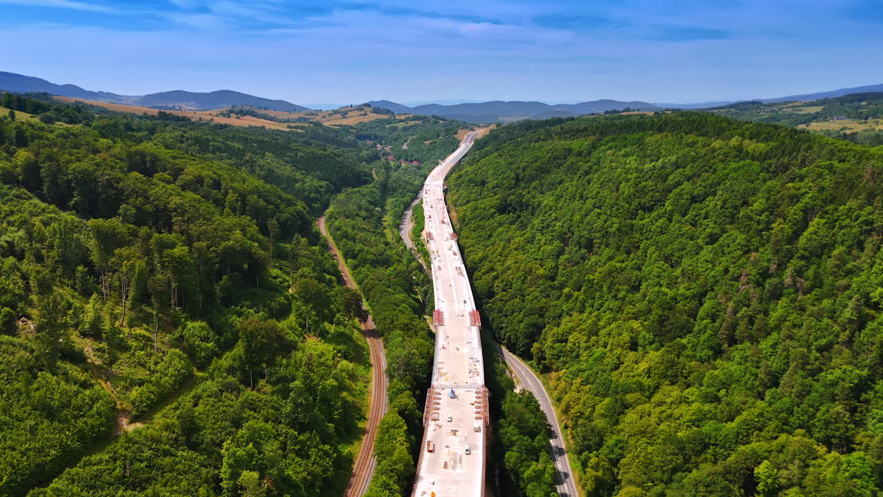 New road construction along the picturesque road. Freeway along the rocky landscape being built