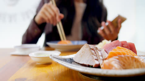 woman having sushi in restaurant 4k