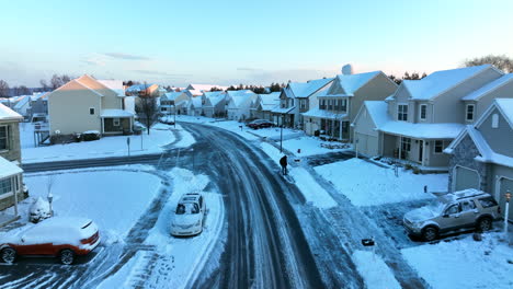 aerial of neighborhood housing covered in winter snow