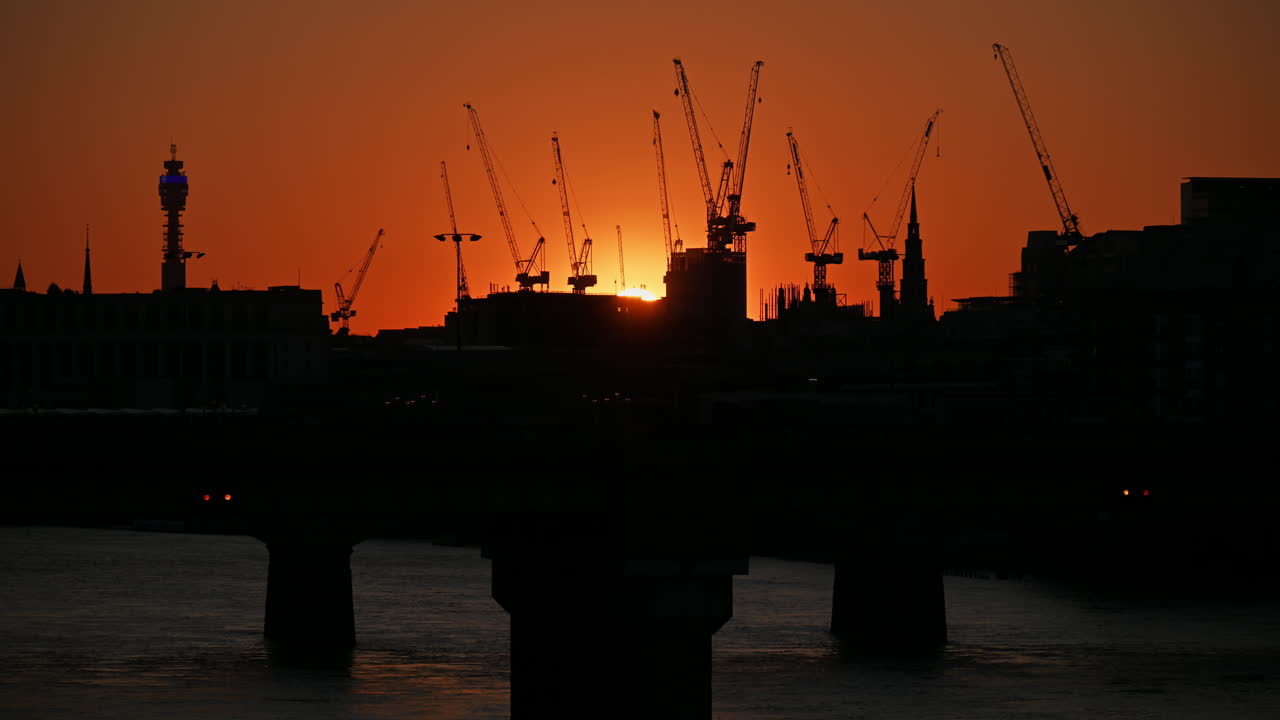 Time lapse of a train moving on Cannon Street Railway Bridge over the Thames River at sunset, London, England