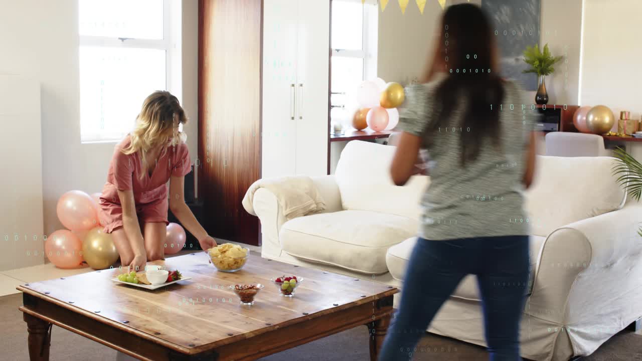 Two women initiating party setup, carrying bowl to coffee table, arranging plates under bunting
