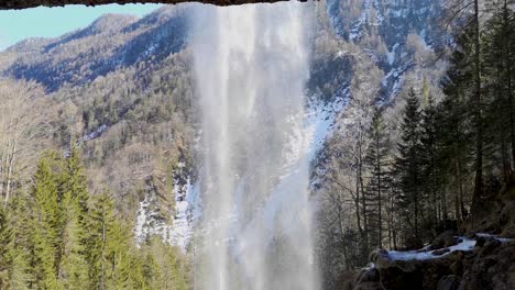 water falling down pericnik waterfall in triglav national park, slovenia