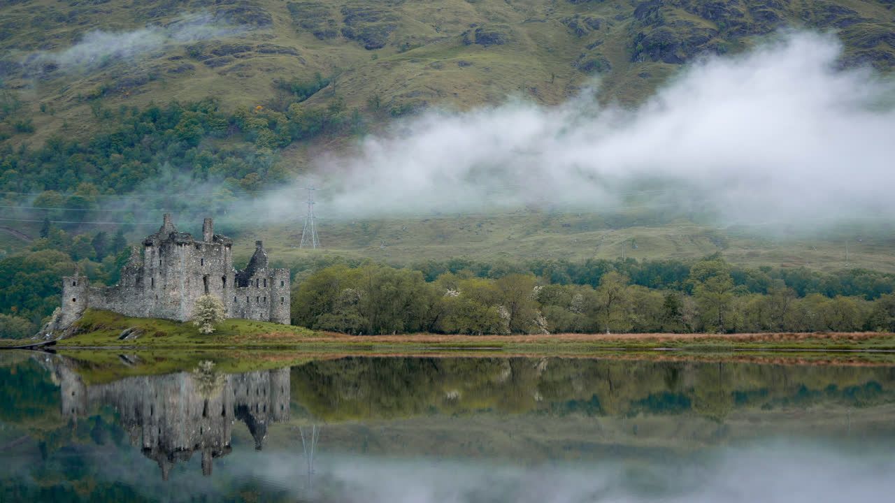 4K - Kilchurn Castle in Scotland Morning Sunrise with Low Clouds