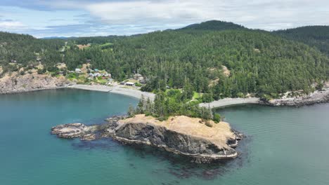 aerial view pushing toward the washington state coast covered with evergreen trees