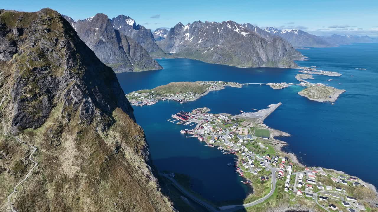 Stunning view of Reine, fjords and jagged Lofoten mountains revealed behind Reinebringen summit