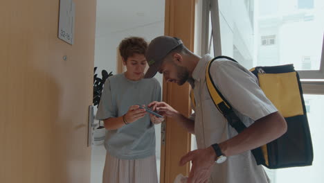 courier delivering food from restaurant to female customer