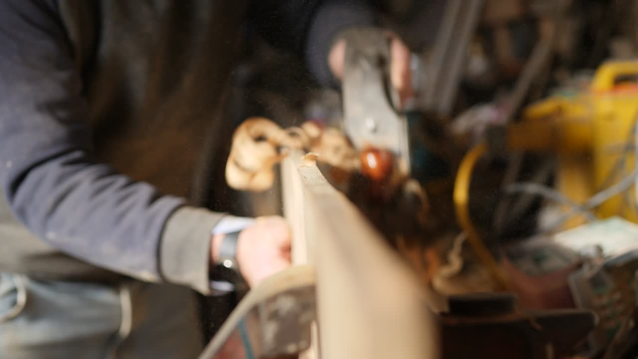 Artisan Working with a Hand Plane, Planing an Iroko Plank Close-Up