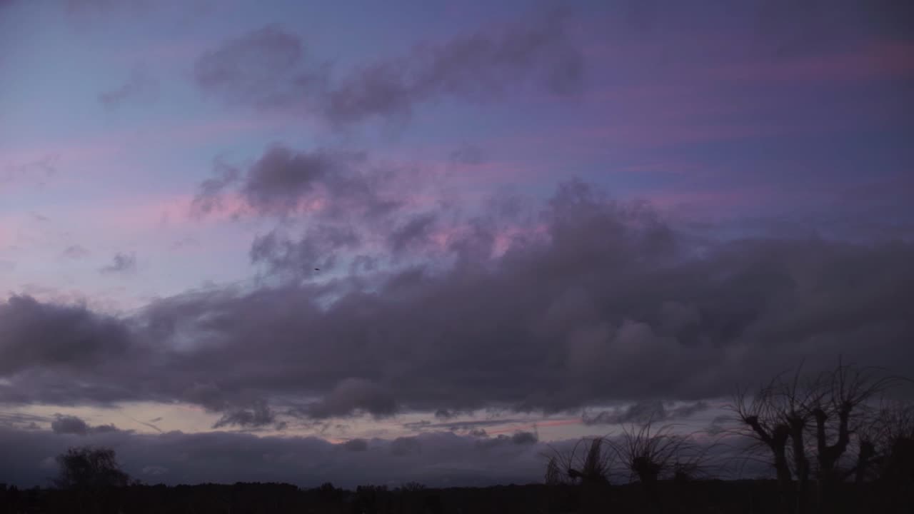 cumulus fluffy cloud moving fast across sky sunset time lapse low