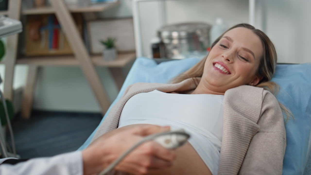 Pregnant woman visiting screening at clinic closeup. Happy expectant mother