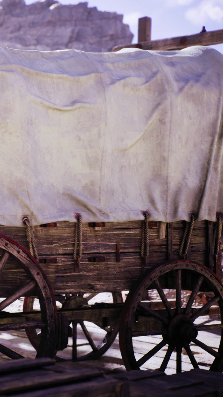 Wagon resting under a soft cloth in a dusty desert landscape