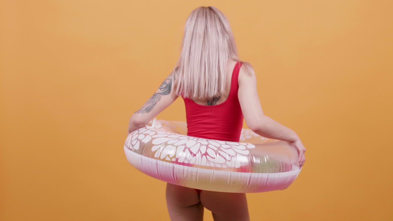 Woman in swimsuit with lifebuoy