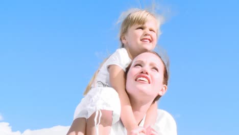 mother with daughter on her shoulders