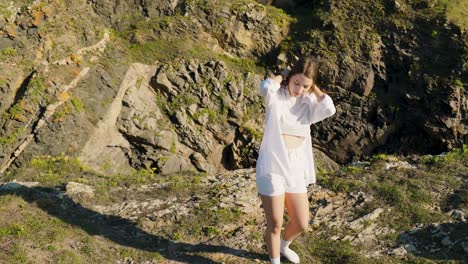 beautiful female tourist standing on coastal cliff near ferrol in galicia, spain