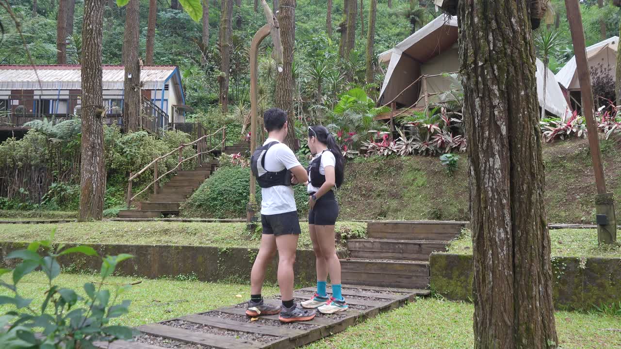 Indonesian young adults using smartphone during trail run in forest
